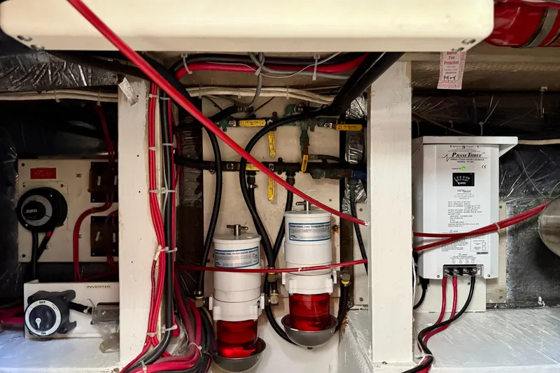 Slide: The Image of Engine room of 1985 Chris-Craft 382 Commander with wiring and fuel filters. - 54