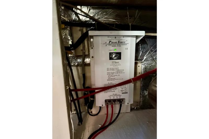 Slide: The Image of Electrical panel inside 1985 Chris-Craft 382 Commander boat, featuring Phase Three charger. - 56