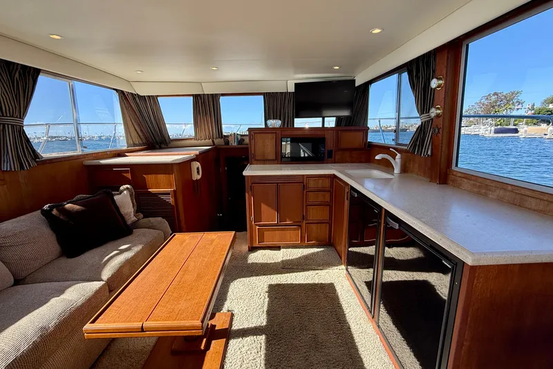 Slide: The Image of Luxurious interior of 1985 Chris-Craft 382 Commander yacht with elegant wood finishes and waterfront views. - 8