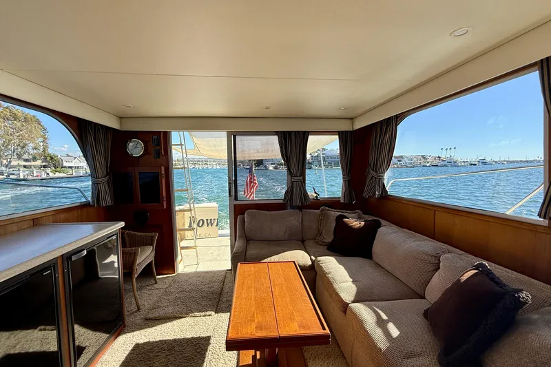 Slide: The Image of Interior of 1985 Chris-Craft 382 Commander yacht with cozy seating and waterfront view. - 9