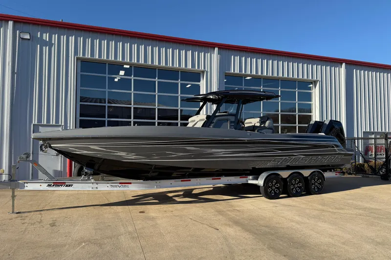 Slide: The Image of 2026 Sunsation 32CCX boat on trailer outside a modern garage. - 2