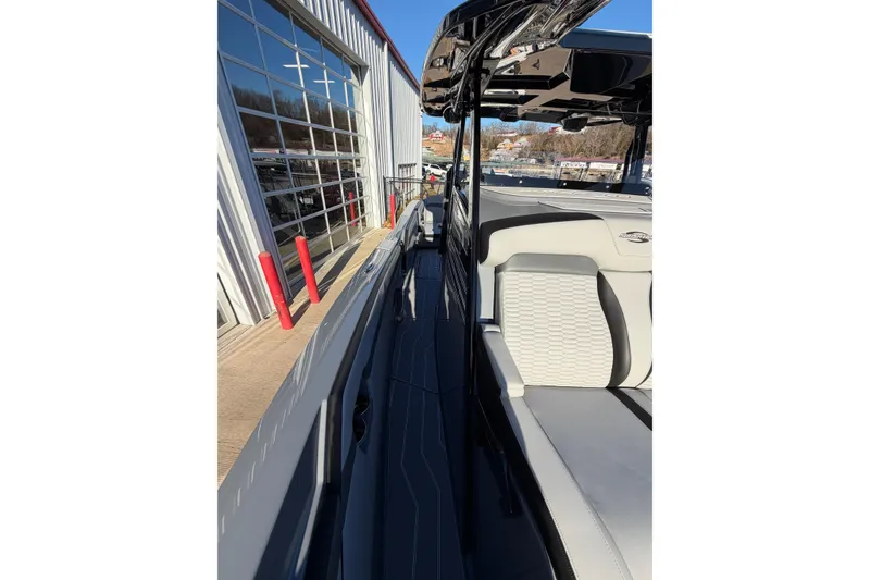 Slide: The Image of 2026 Sunsation 32CCX boat with sleek design and modern seating near a showroom. - 20