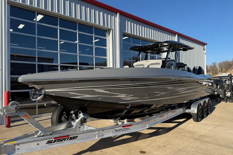 Slide: The Image of 2026 Sunsation 32CCX boat on trailer outside a modern garage. - 4