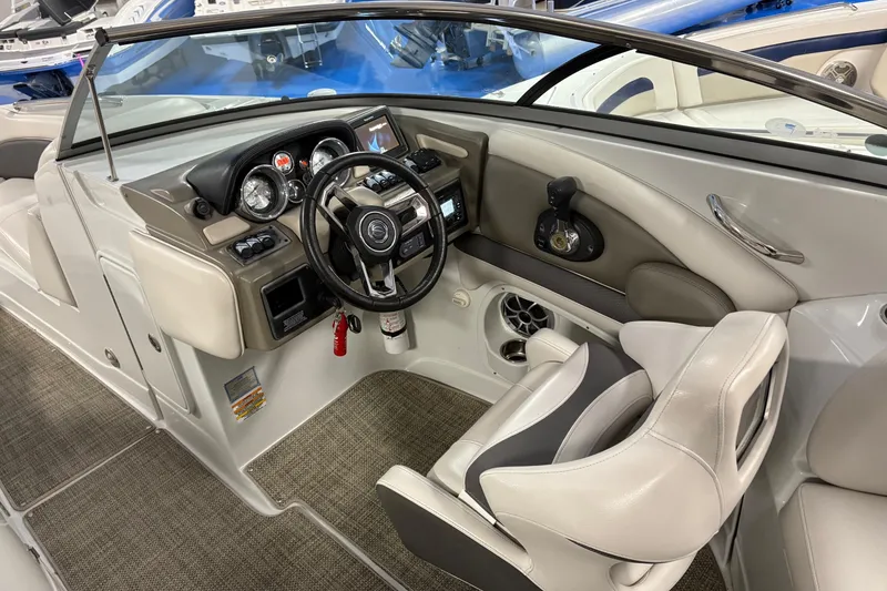 Slide: The Image of 2017 Crownline 275 SS boat interior with steering wheel and dashboard controls. - 10