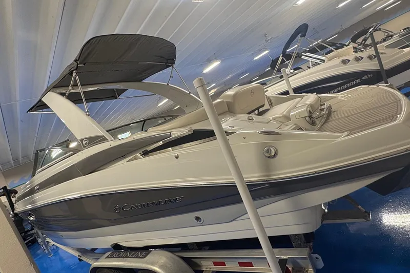 Slide: The Image of 2017 Crownline 275 SS boat with canopy in showroom display. - 2