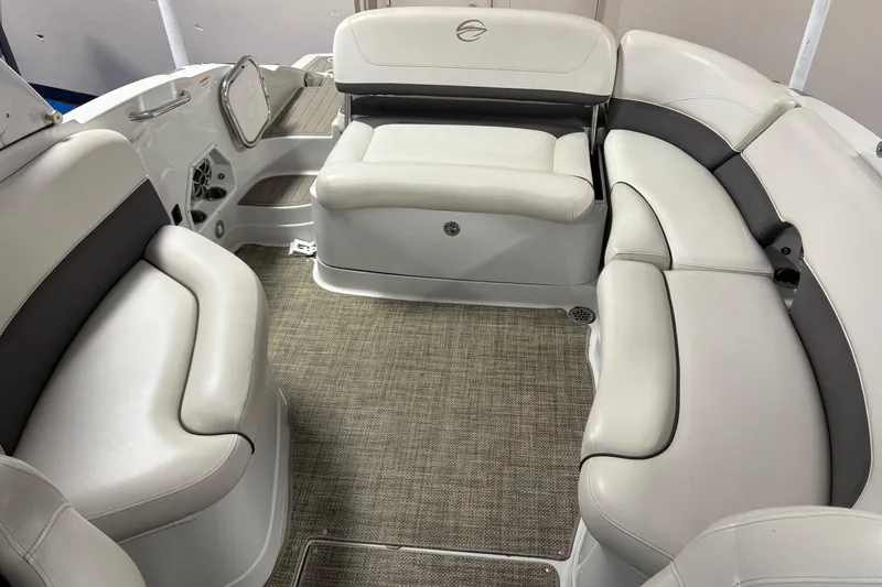 Slide: The Image of 2017 Crownline 275 SS boat interior with plush white seating and carpeted flooring. - 5