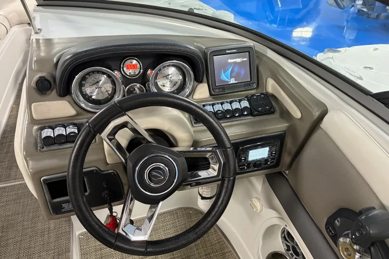 Slide: The Image of 2017 Crownline 275 SS boat dashboard with steering wheel, gauges, and navigation system. - 9