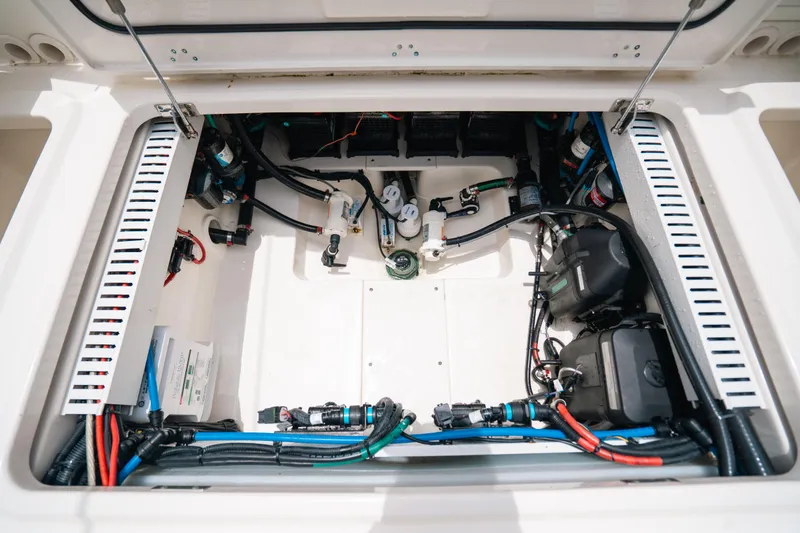 Slide: The Image of 2019 Boston Whaler 330 Outrage engine compartment with wiring and components. - 12
