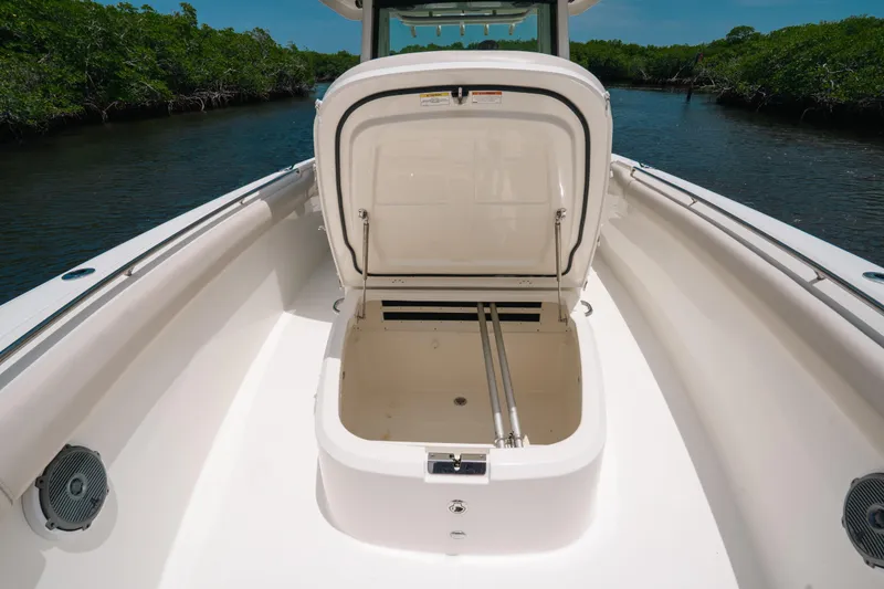 Slide: The Image of 2019 Boston Whaler 330 Outrage boat with open storage compartment on deck. - 13
