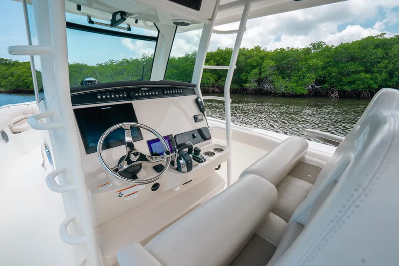 Slide: The Image of 2019 Boston Whaler 330 Outrage boat interior with steering wheel and control panel. - 6