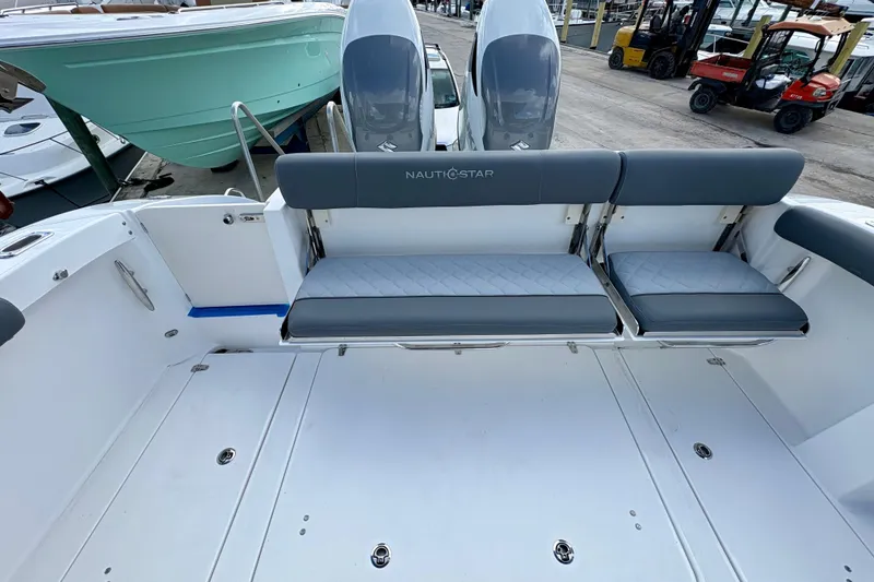 Slide: The Image of 2026 NauticStar 332 Offshore boat with foldable seating and dual engines. - 10