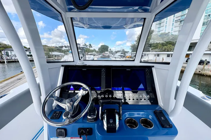 Slide: The Image of 2026 NauticStar 332 Offshore boat helm with modern controls and dual displays. - 5