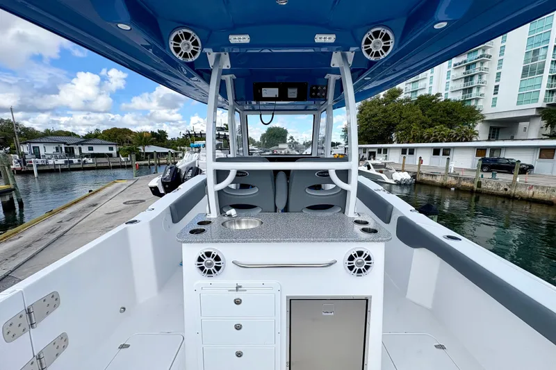 Slide: The Image of 2026 NauticStar 332 Offshore boat interior with modern amenities, docked at a marina. - 6