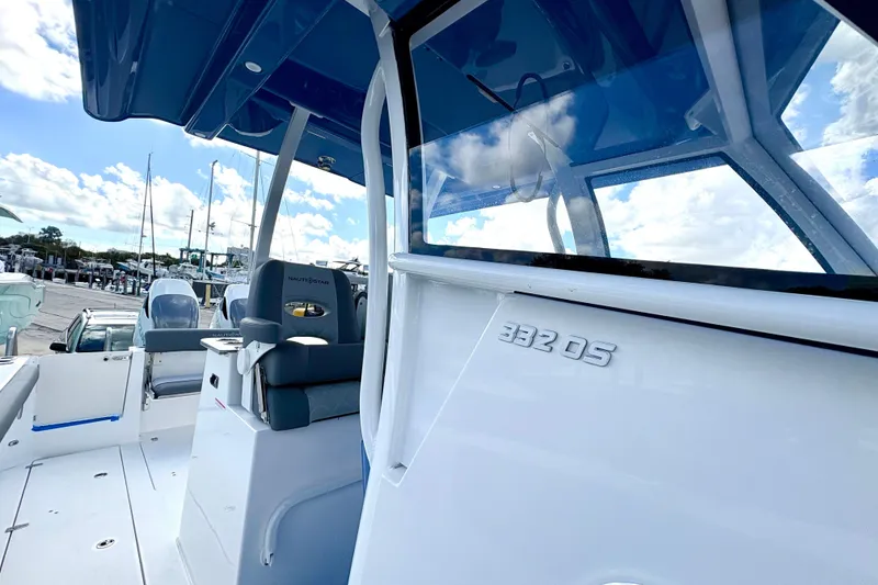 Slide: The Image of 2026 NauticStar 332 Offshore boat interior with blue canopy and seating. - 7