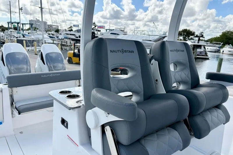 Slide: The Image of Luxury seating on 2026 NauticStar 332 Offshore boat, docked at marina. - 8