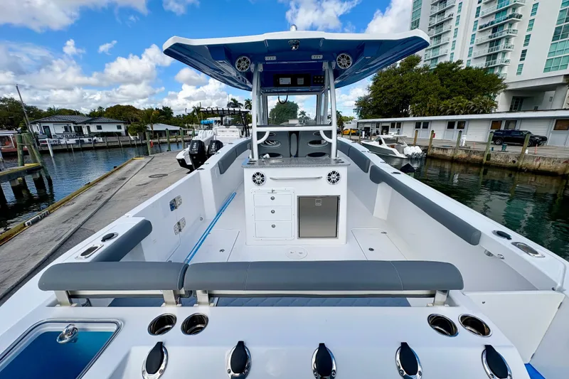 Slide: The Image of 2026 NauticStar 332 Offshore boat docked, featuring spacious deck and modern amenities. - 9
