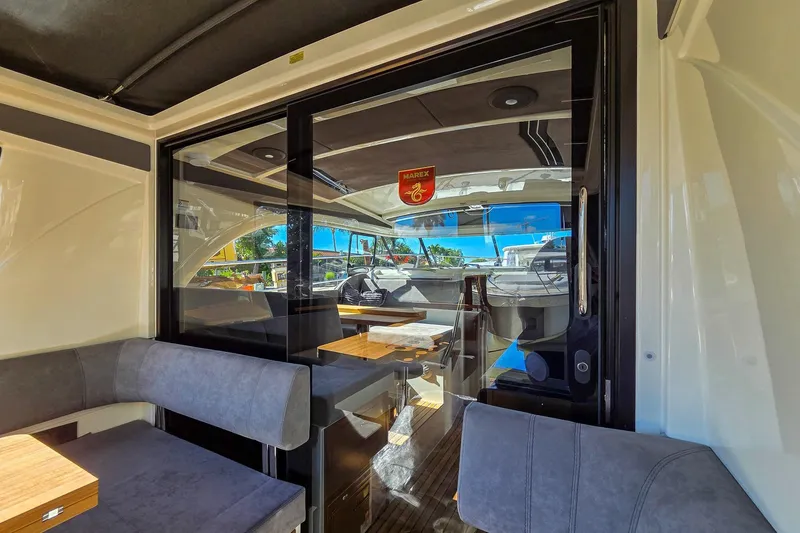 Slide: The Image of Luxurious interior of 2026 Marex 330 Scandinavia yacht with elegant seating and wooden table. - 13