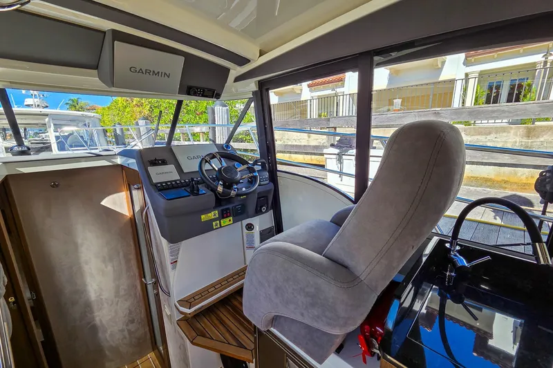 Slide: The Image of Luxurious interior of 2026 Marex 330 Scandinavia yacht with elegant seating and wooden table. - 18