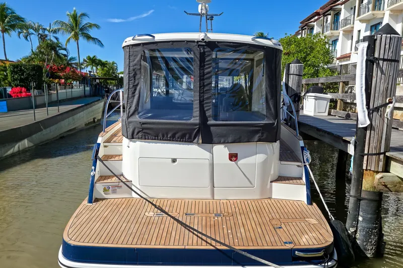 Slide: The Image of Helm of 2026 Marex 330 Scandinavia boat with navigation screens and plush seating. - 2