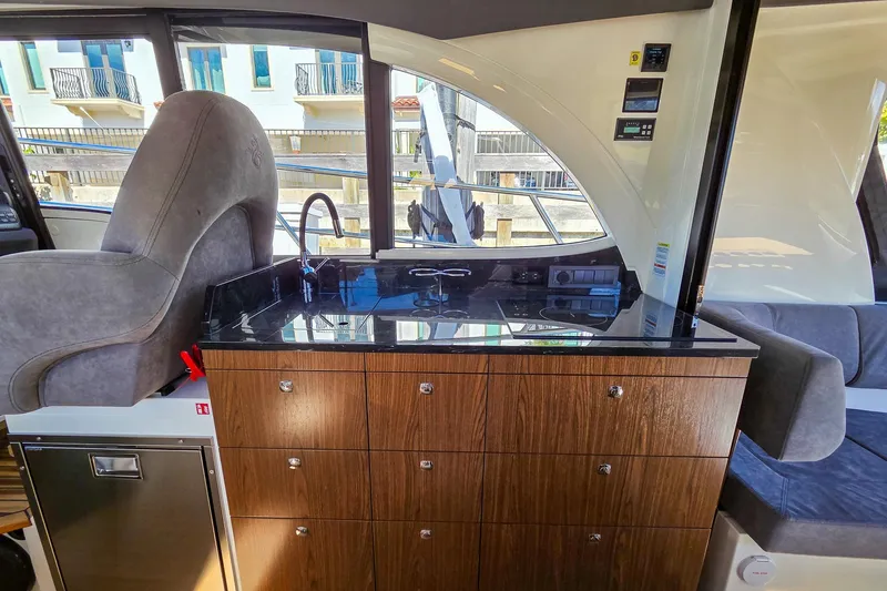 Slide: The Image of Interior of 2026 Marex 330 Scandinavia yacht with sleek wood cabinetry and modern design. - 17