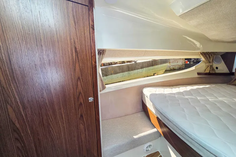 Slide: The Image of Interior of 2026 Marex 330 Scandinavia boat, featuring a cozy cabin with a bed. - 27