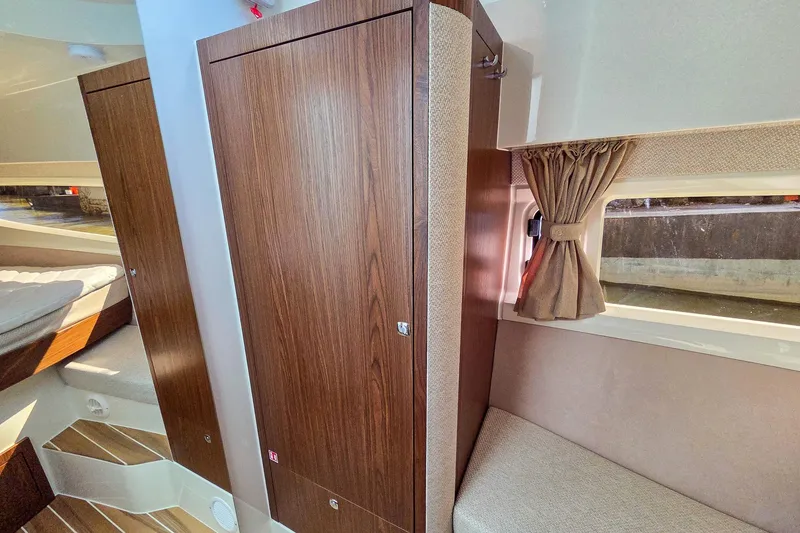 Slide: The Image of Interior of 2026 Marex 330 Scandinavia boat with wood paneling and cozy seating. - 30