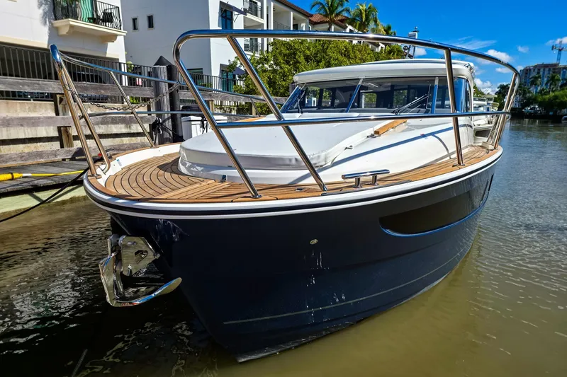 Slide: The Image of 2026 Marex 330 Scandinavia boat docked on a sunny day, showcasing sleek design. - 5