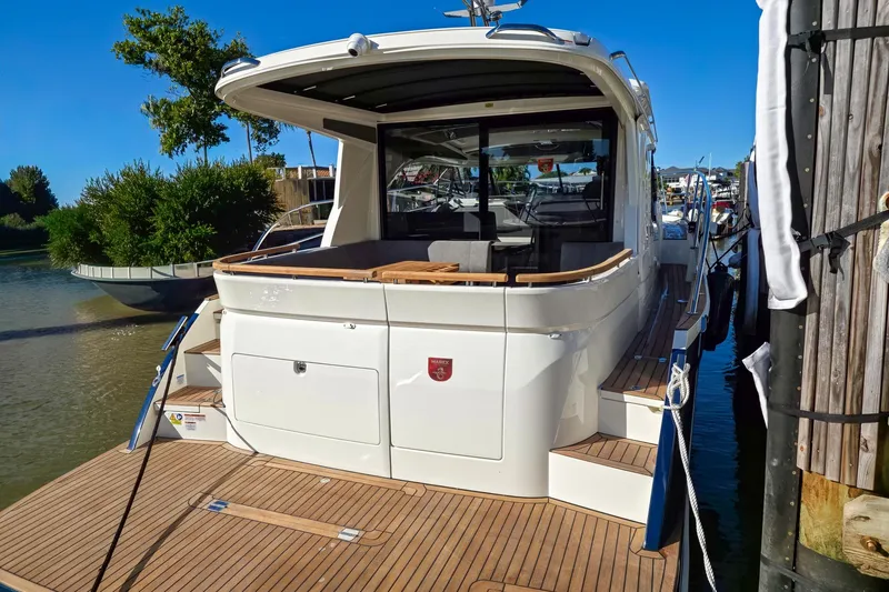 Slide: The Image of 2026 Marex 330 Scandinavia yacht docked, showcasing sleek design and spacious deck. - 6