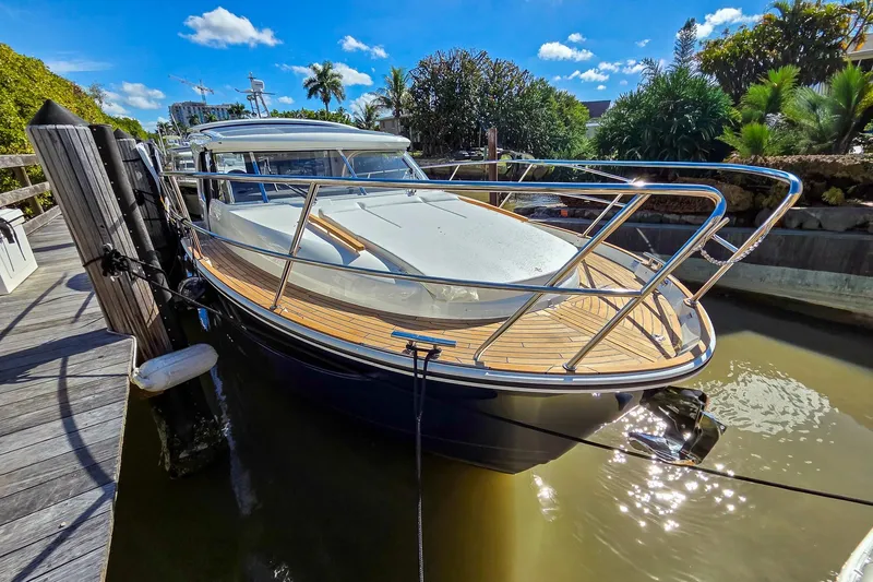 The Image of 2026 Marex 330 Scandinavia yacht docked, featuring sleek design and wooden deck. - 0