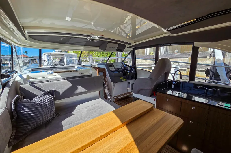 Slide: The Image of Interior of 2026 Marex 330 Scandinavia yacht with modern seating and navigation area. - 16