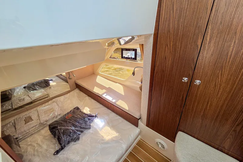 Slide: The Image of Interior cabin of 2026 Marex 330 Scandinavia yacht with wood finishes and cozy bedding. - 22