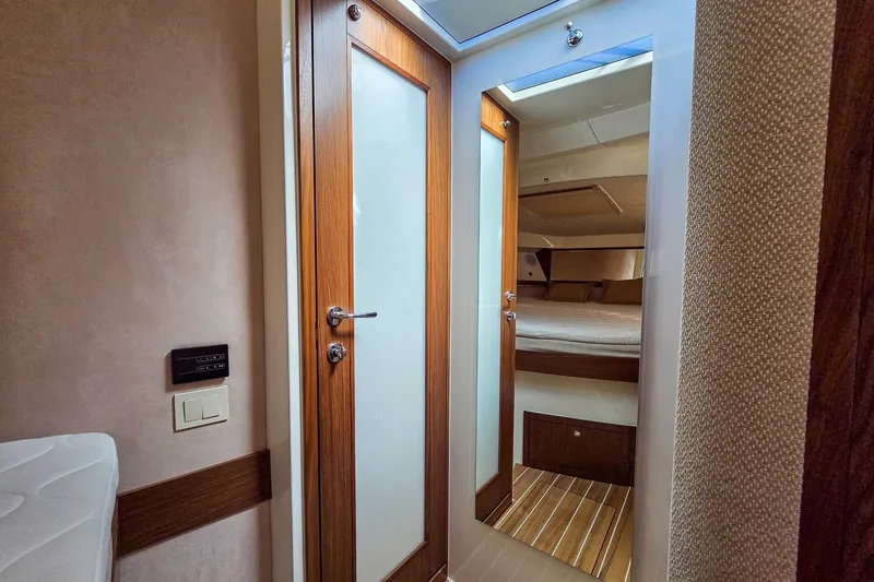 Slide: The Image of Interior of 2026 Marex 330 Scandinavia yacht, featuring wooden doors and cozy cabin. - 29