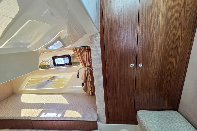 Slide: The Image of Interior of 2026 Marex 330 Scandinavia boat, featuring cozy cabin and wooden cabinetry. - 31