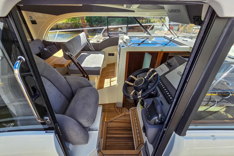 Slide: The Image of Interior of 2026 Marex 330 Scandinavia yacht with modern helm and seating area. - 33