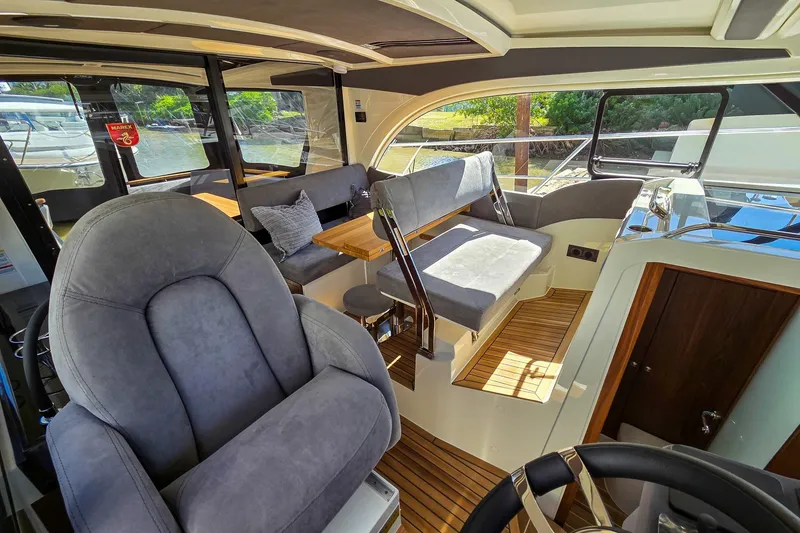 Slide: The Image of Interior of 2026 Marex 330 Scandinavia yacht with plush seating and wooden flooring. - 34