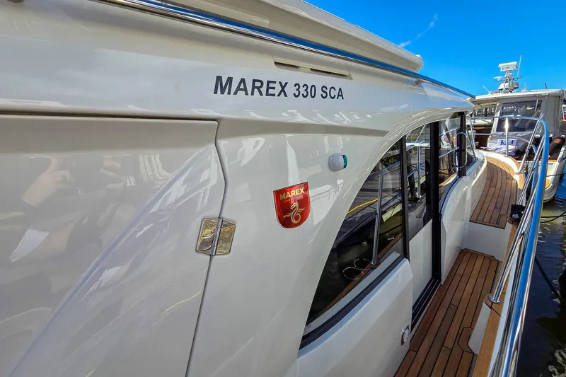 Slide: The Image of 2026 Marex 330 Scandinavia yacht with sleek design and wooden deck details. - 35