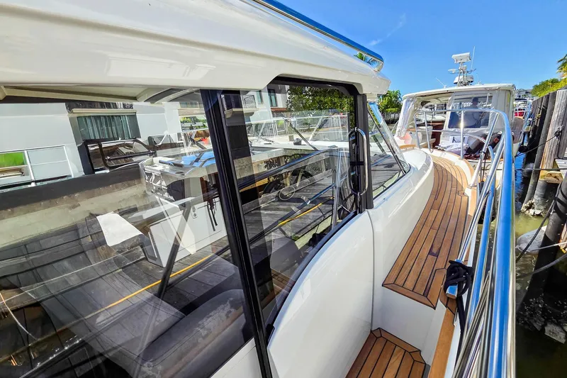 Slide: The Image of 2026 Marex 330 Scandinavia yacht with sleek design and wooden deck, docked in marina. - 36