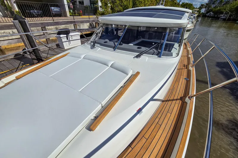 Slide: The Image of 2026 Marex 330 Scandinavia yacht with sleek design and wooden deck, docked by the water. - 38