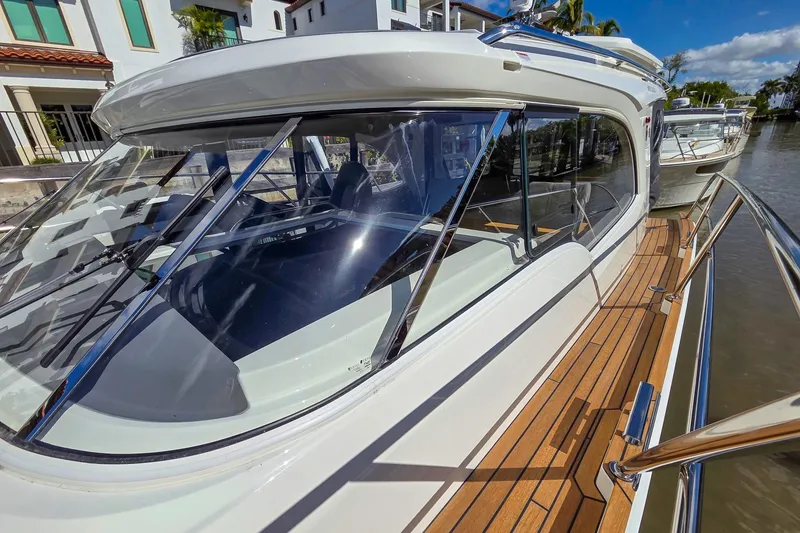 Slide: The Image of 2026 Marex 330 Scandinavia yacht with sleek design and wooden deck by the water. - 39