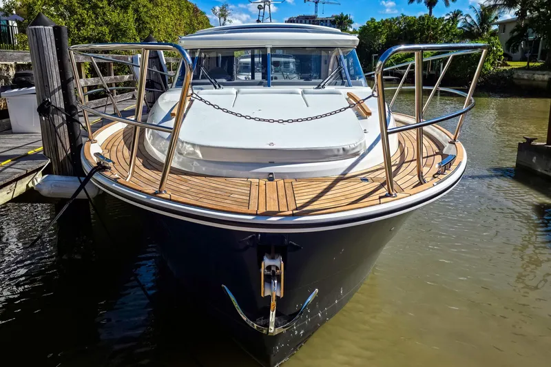 Slide: The Image of 2026 Marex 330 Scandinavia yacht docked, showcasing sleek design and wooden deck. - 4