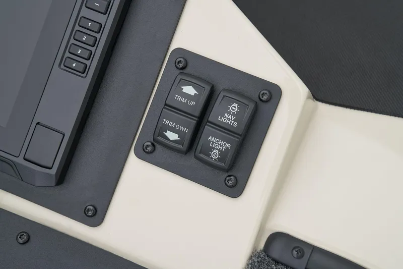 Slide: The Image of Manufacturer Provided Image: Control panel of 2026 Ranger Z185 boat with trim and light switches. - 21
