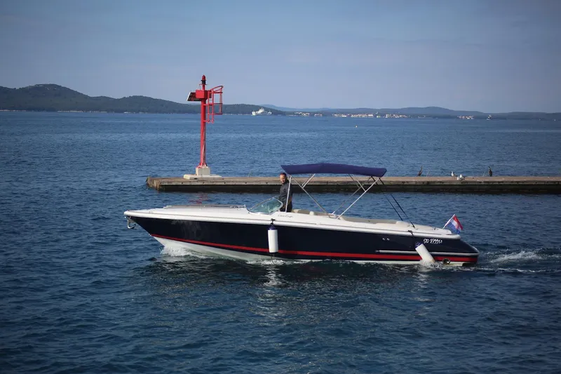 The Image of 2004 Chris-Craft Corsair 28 boat cruising near a red navigation marker. - 0