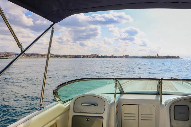 Slide: The Image of 2004 Chris-Craft Corsair 28 boat on water, city skyline in background. - 4