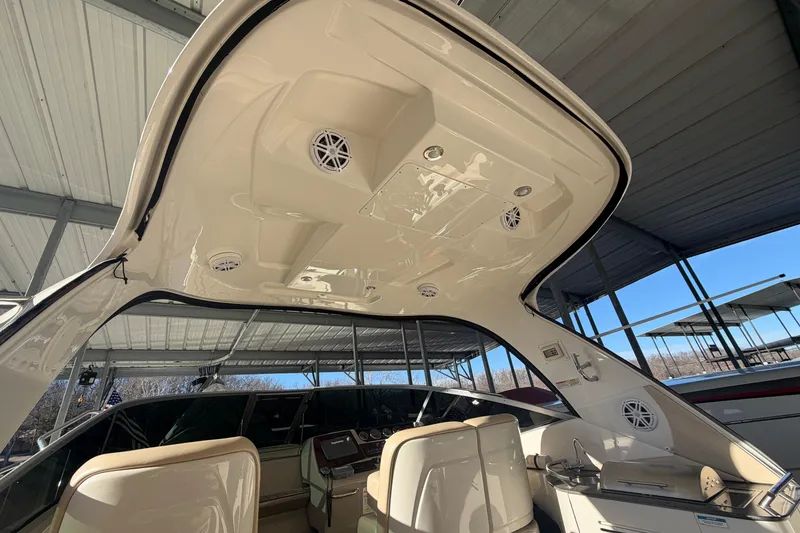 Slide: The Image of 2014 Sea Ray 370 Sundancer boat interior with seating and overhead speakers. - 14