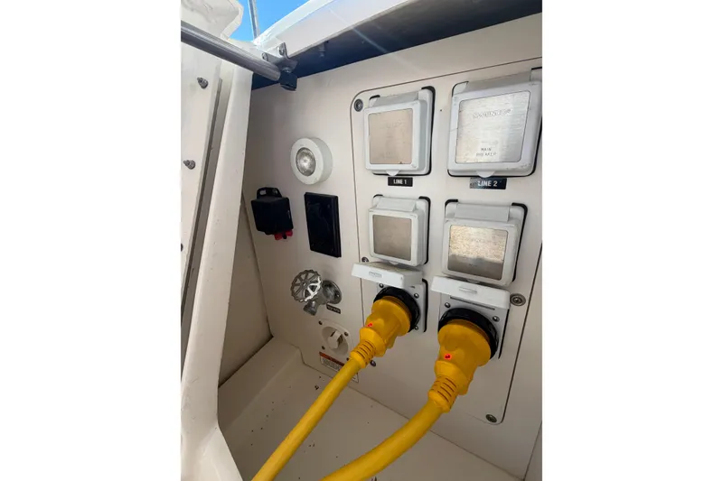 Slide: The Image of Electrical panel of 2014 Sea Ray 370 Sundancer with yellow power cables connected. - 16