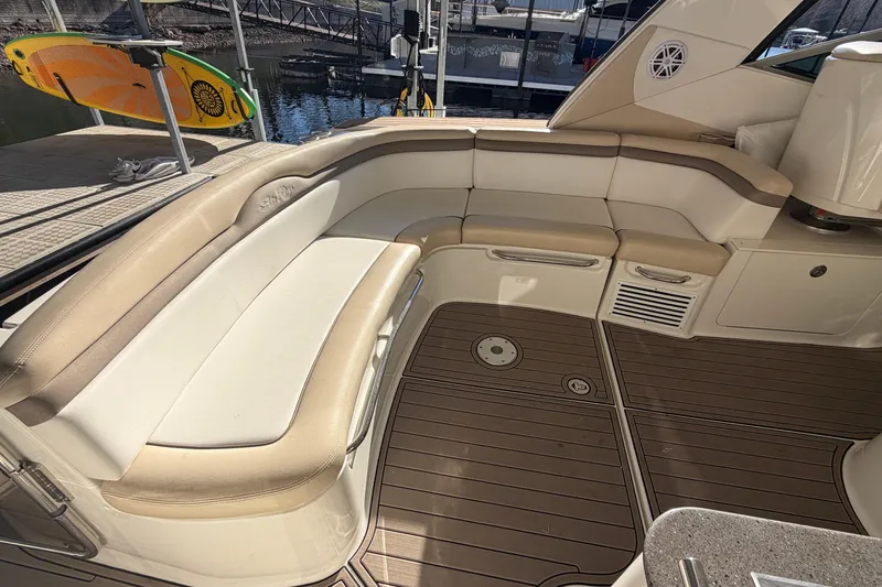 Slide: The Image of 2014 Sea Ray 370 Sundancer interior with beige seating and teak flooring. - 20