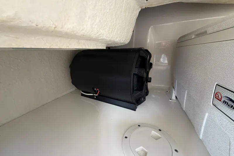 Slide: The Image of 2014 Sea Ray 370 Sundancer interior with black speaker and storage compartment. - 31