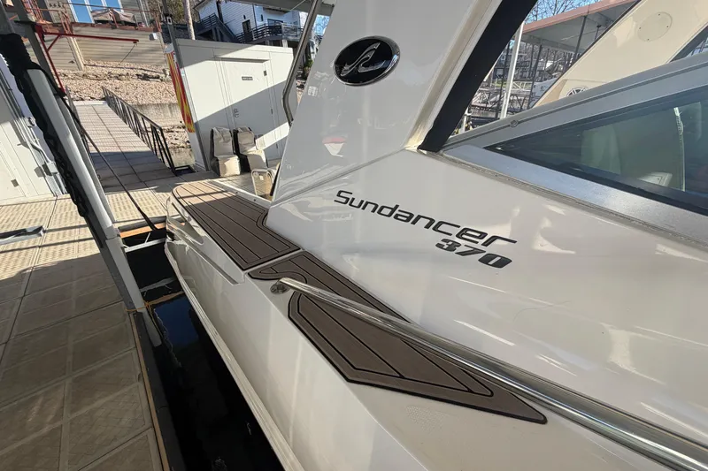 Slide: The Image of 2014 Sea Ray 370 Sundancer docked, showcasing sleek design and branding. - 4