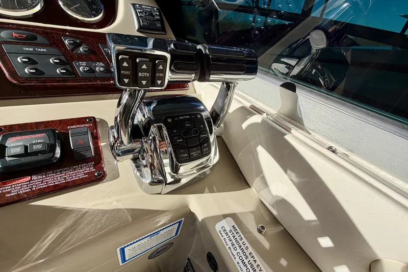 Slide: The Image of Control panel of a 2014 Sea Ray 370 Sundancer boat with throttle and switches. - 40