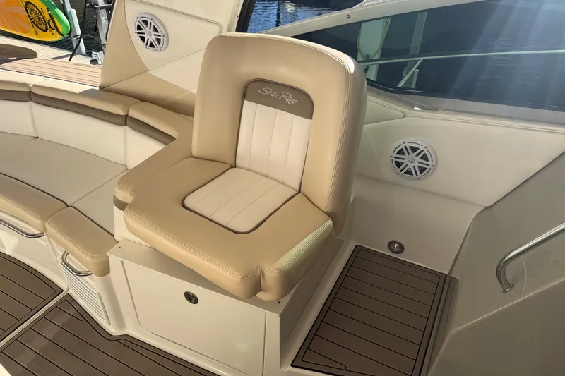 Slide: The Image of Luxury seating on 2014 Sea Ray 370 Sundancer boat, featuring beige upholstery and wood accents. - 43